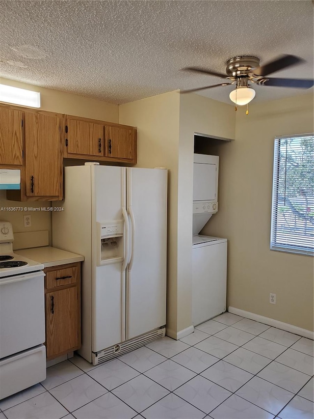 kitchen featuring ceiling fan, ventilation hood, stacked washer / dryer, white appliances, and light tile patterned floors