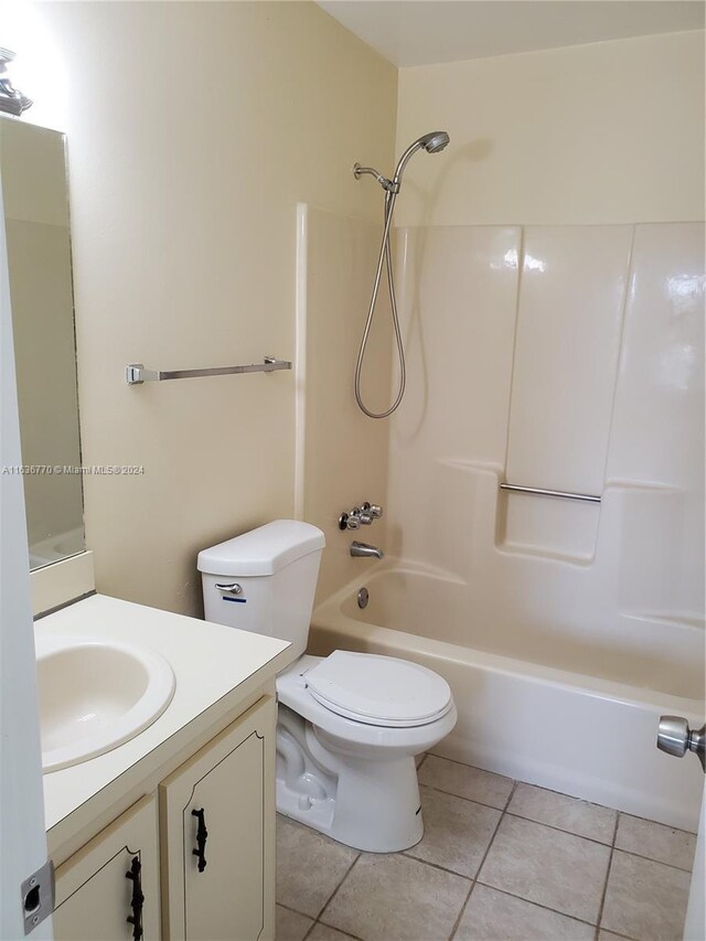 full bathroom featuring shower / bath combination, vanity, tile patterned floors, and toilet