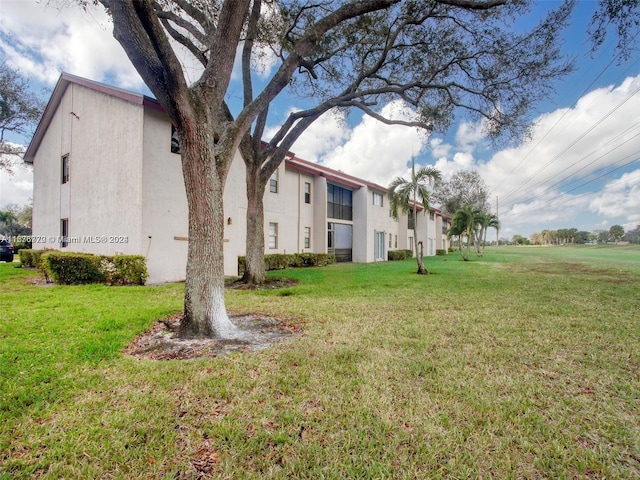 view of side of home featuring a yard