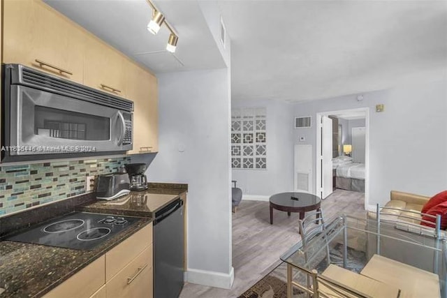 kitchen with light hardwood / wood-style floors, light brown cabinetry, backsplash, and track lighting