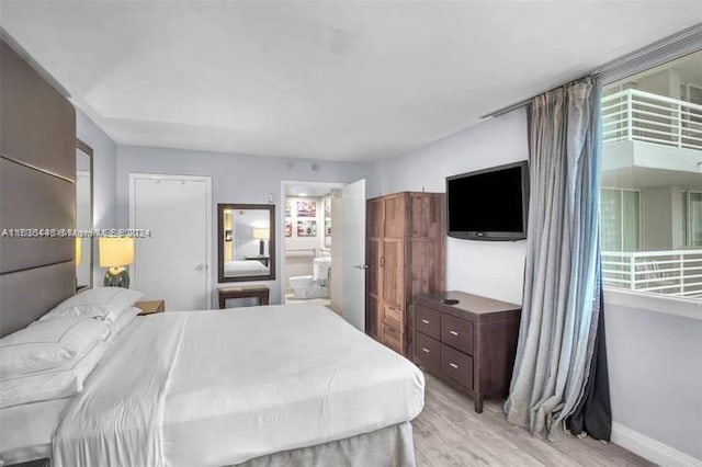 bedroom with multiple windows and light wood-type flooring