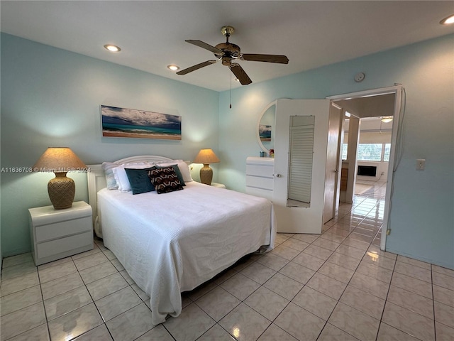 bedroom with ceiling fan and light tile patterned floors