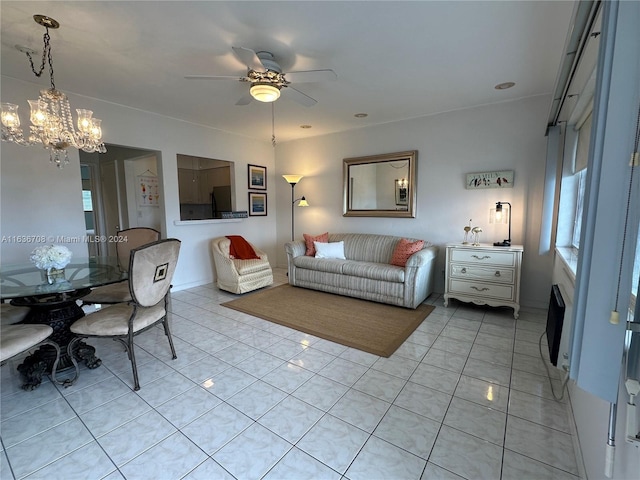 living room featuring ceiling fan with notable chandelier and light tile patterned floors