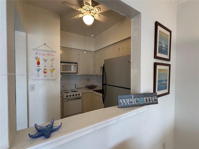 kitchen featuring kitchen peninsula, white appliances, and ceiling fan