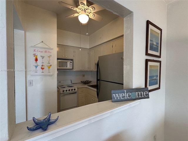 801 Atlantic Shores Blvd Unit 207, Hallandale Beach, FL 33009 - kitchen featuring appliances with stainless steel finishes, ceiling fan, light countertops, and a peninsula