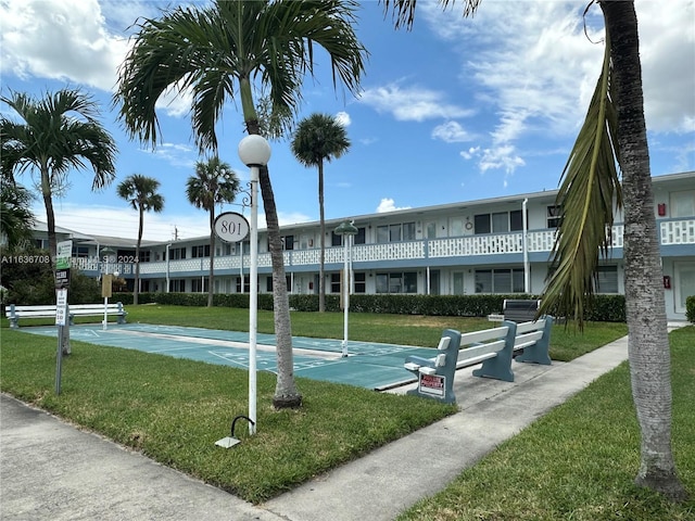801 Atlantic Shores Blvd Unit 207, Hallandale Beach, FL 33009 - surrounding community with a lawn and shuffleboard