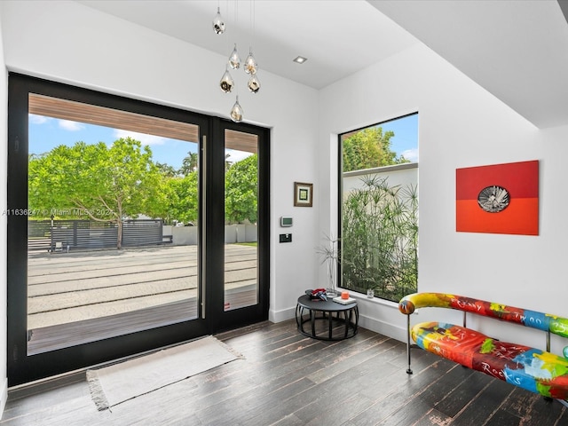 doorway featuring hardwood / wood-style floors and an inviting chandelier