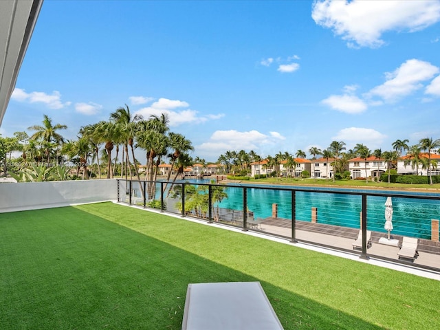 view of swimming pool with a lawn