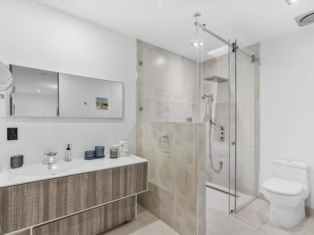 bathroom with vanity, toilet, a shower with door, and tile patterned floors