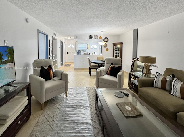 living room featuring light tile patterned floors and a textured ceiling