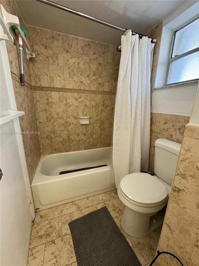 bathroom with shower / tub combo and toilet