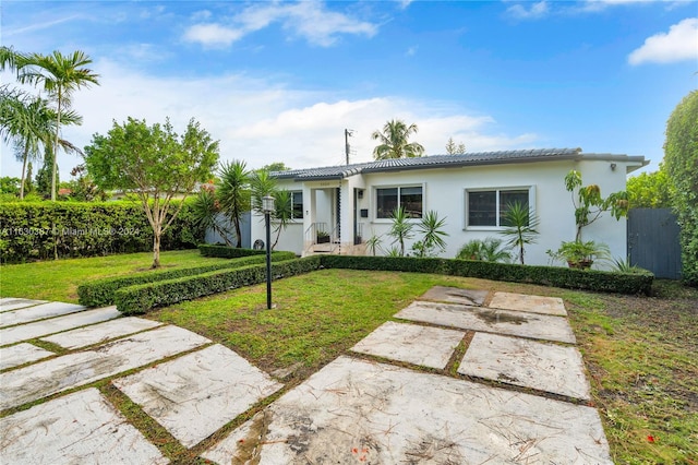 view of front of home with a front lawn and a patio area