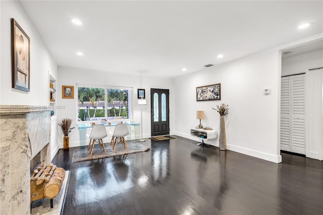 entryway featuring dark hardwood / wood-style flooring and a premium fireplace