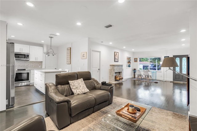 living room featuring dark hardwood / wood-style flooring and a premium fireplace