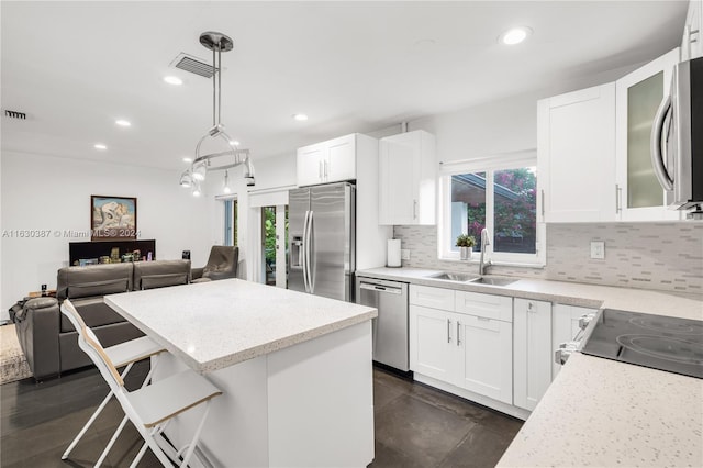 kitchen featuring sink, a wealth of natural light, tasteful backsplash, and stainless steel appliances