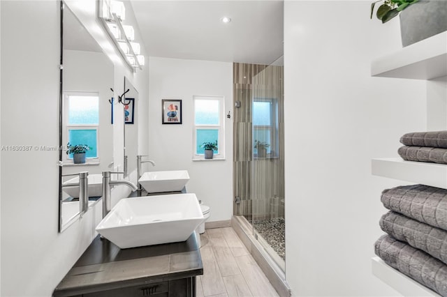 bathroom featuring dual bowl vanity and an enclosed shower