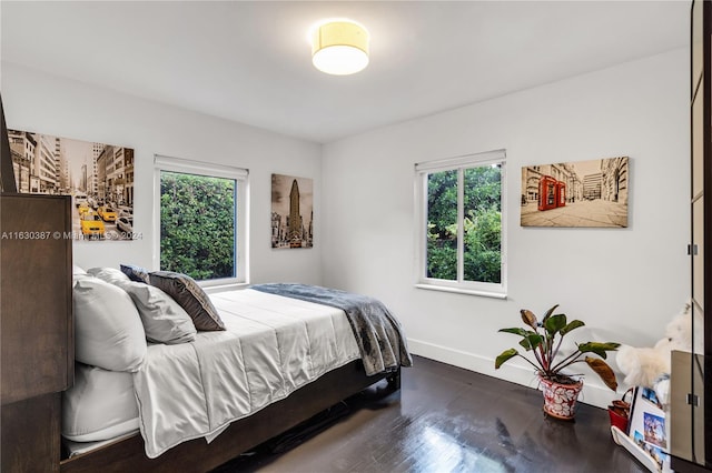 bedroom featuring dark hardwood / wood-style floors and multiple windows