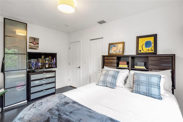 bedroom with dark hardwood / wood-style flooring