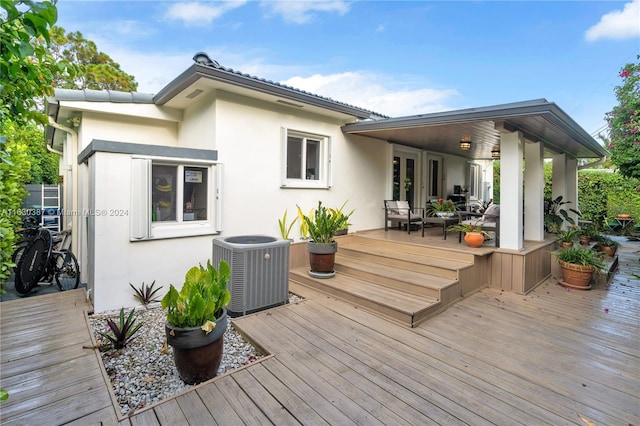 wooden terrace featuring central air condition unit