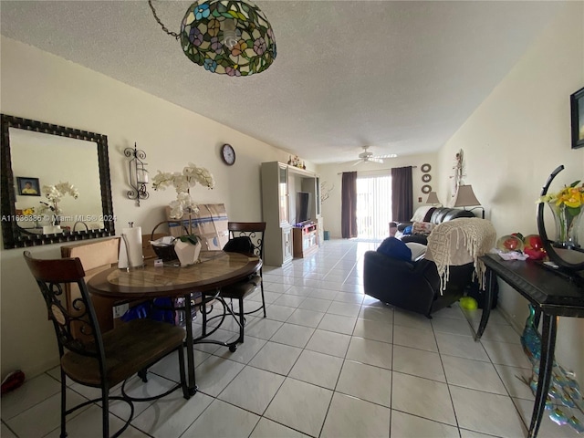 tiled dining room featuring ceiling fan and a textured ceiling