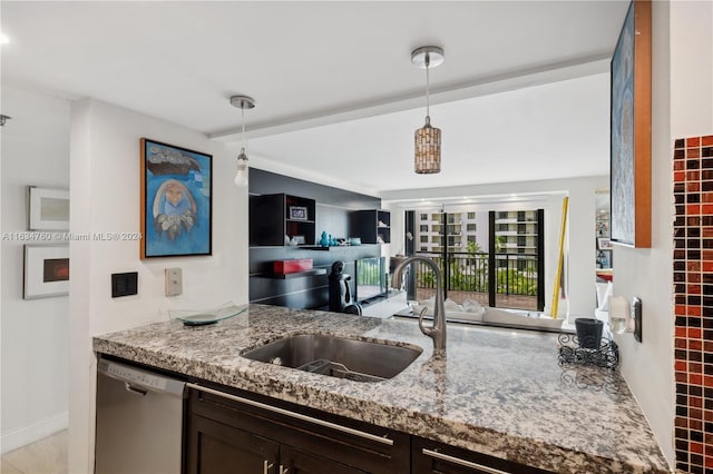 kitchen with stainless steel dishwasher, dark brown cabinets, light stone countertops, and decorative light fixtures