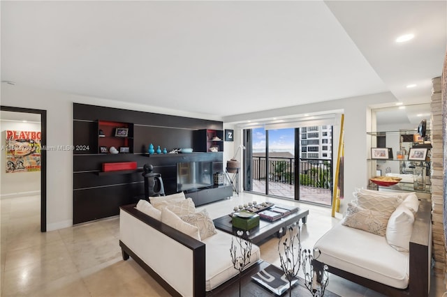 living room with built in features and light tile patterned floors