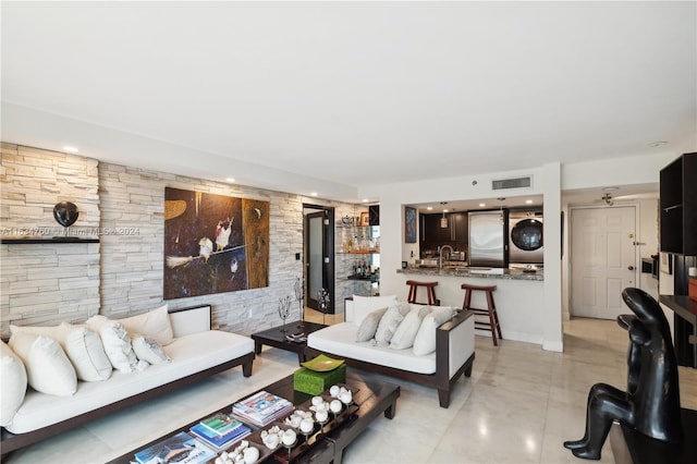 tiled living room featuring sink