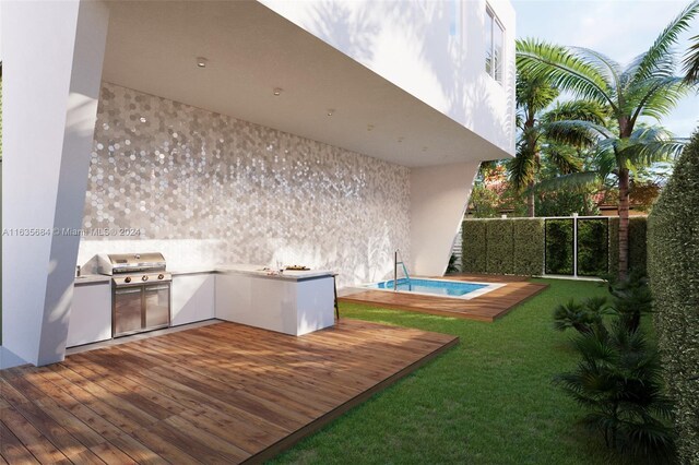 exterior space featuring exterior kitchen, a wooden deck, a lawn, and grilling area