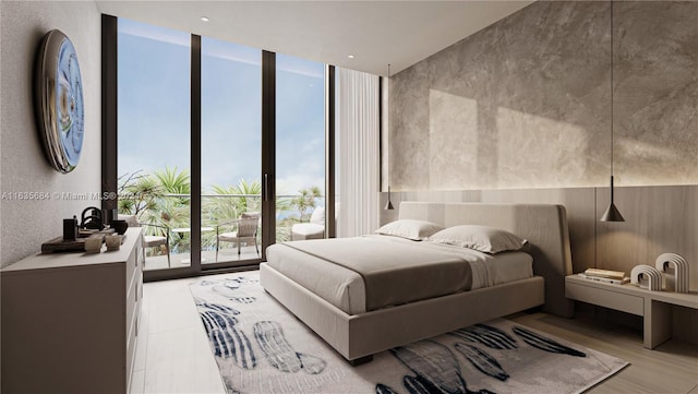 bedroom featuring access to outside, floor to ceiling windows, and light wood-type flooring