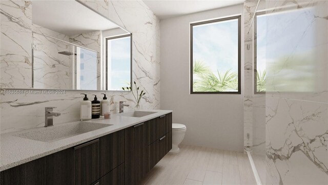 bathroom featuring tile patterned floors, tile walls, double vanity, and toilet