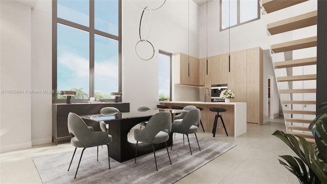 dining area featuring a towering ceiling