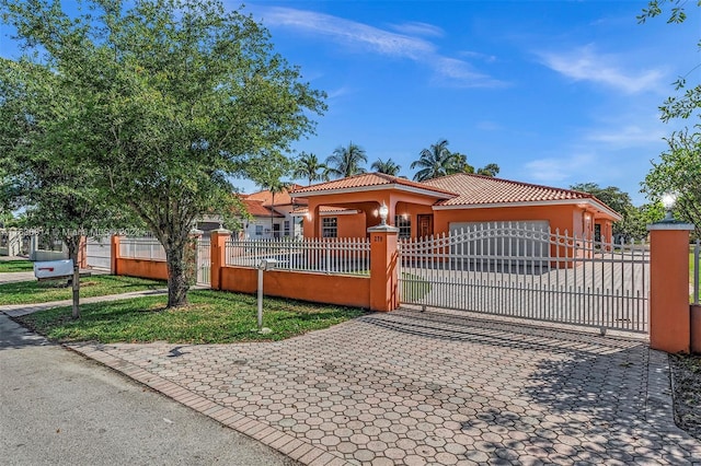 279 NW 119th Ave, Miami, FL 33182 - mediterranean / spanish house featuring a fenced front yard, stucco siding, a tiled roof, decorative driveway, and a garage