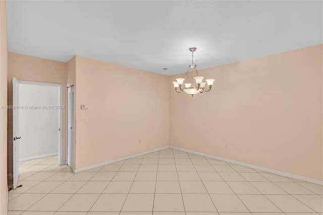 279 NW 119th Ave, Miami, FL 33182 - unfurnished room with baseboards, light tile patterned floors, and a notable chandelier
