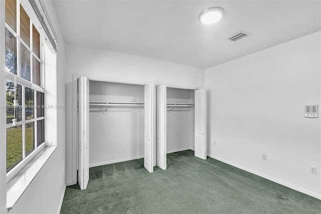 279 NW 119th Ave, Miami, FL 33182 - unfurnished bedroom with baseboards, visible vents, two closets, and carpet