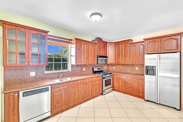 279 NW 119th Ave, Miami, FL 33182 - kitchen featuring stainless steel appliances, tasteful backsplash, glass insert cabinets, a sink, and light tile patterned floors