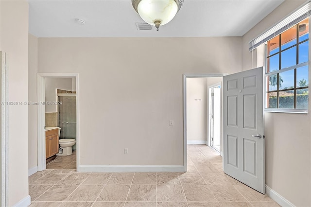 279 NW 119th Ave, Miami, FL 33182 - unfurnished bedroom with ensuite bathroom, baseboards, and visible vents