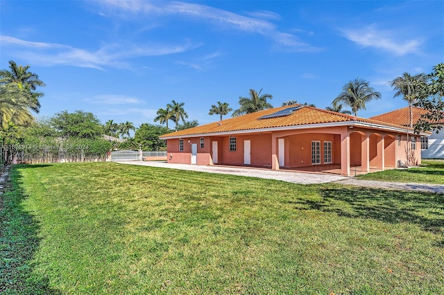 279 NW 119th Ave, Miami, FL 33182 - back of property with roof mounted solar panels, fence, a yard, and a patio