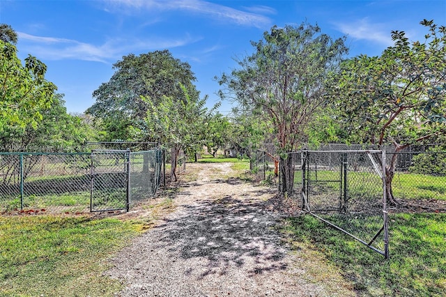 279 NW 119th Ave, Miami, FL 33182 - view of street featuring driveway, a gate, and a gated entry