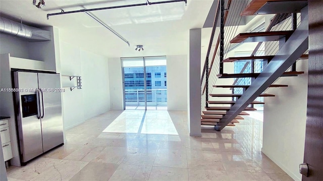 interior space featuring rail lighting and expansive windows