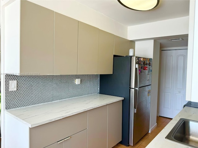 kitchen with light hardwood / wood-style floors and backsplash