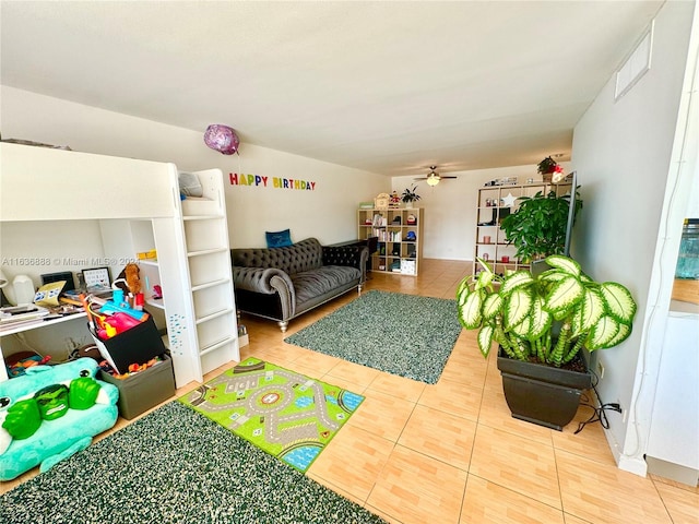 game room featuring tile patterned floors and ceiling fan