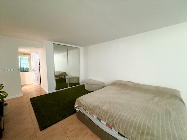 tiled bedroom with a closet