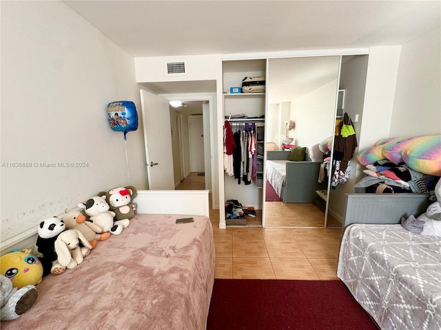 bedroom featuring tile patterned floors and a closet