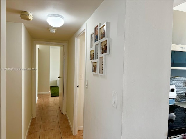 corridor featuring light tile patterned floors