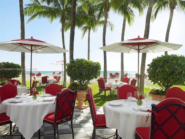 view of patio featuring a water view and outdoor dining area