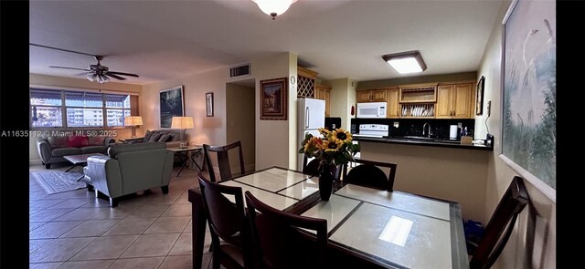 dining room with light tile patterned floors and baseboards