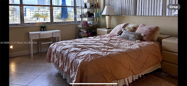 bedroom featuring tile patterned floors and a city view