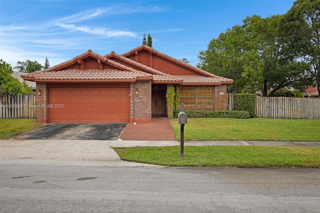 view of front of home with a garage and a front lawn