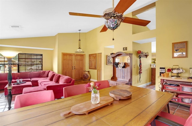 dining area featuring ceiling fan and high vaulted ceiling