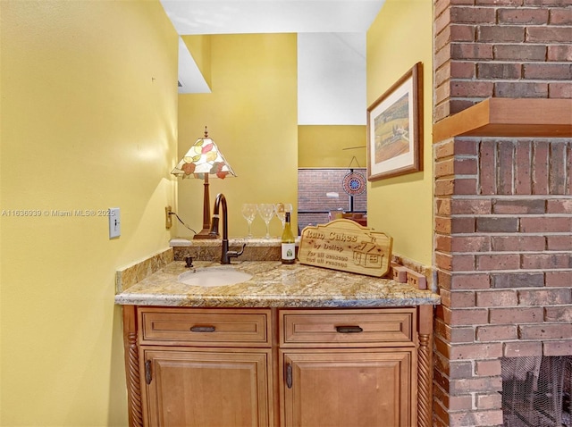 bathroom featuring vanity and a fireplace